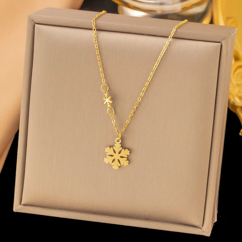 Gold Snowflake Pendant Necklace with Star Accent